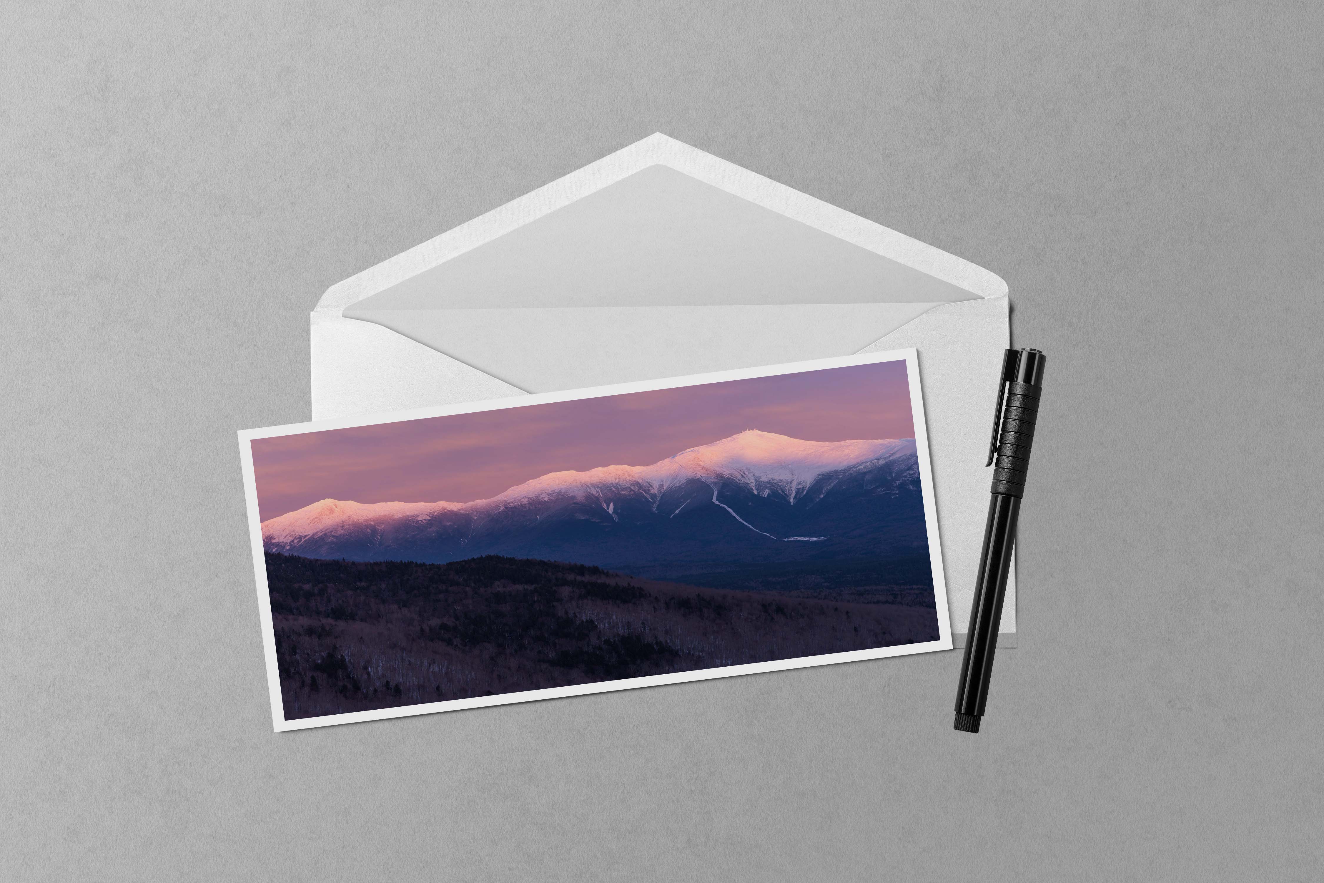 A panorama photo of sunset alpenglow lighting up Mount Monroe, Mount Washington, and Mount Jefferson in the Presidential Range of New Hampshire.