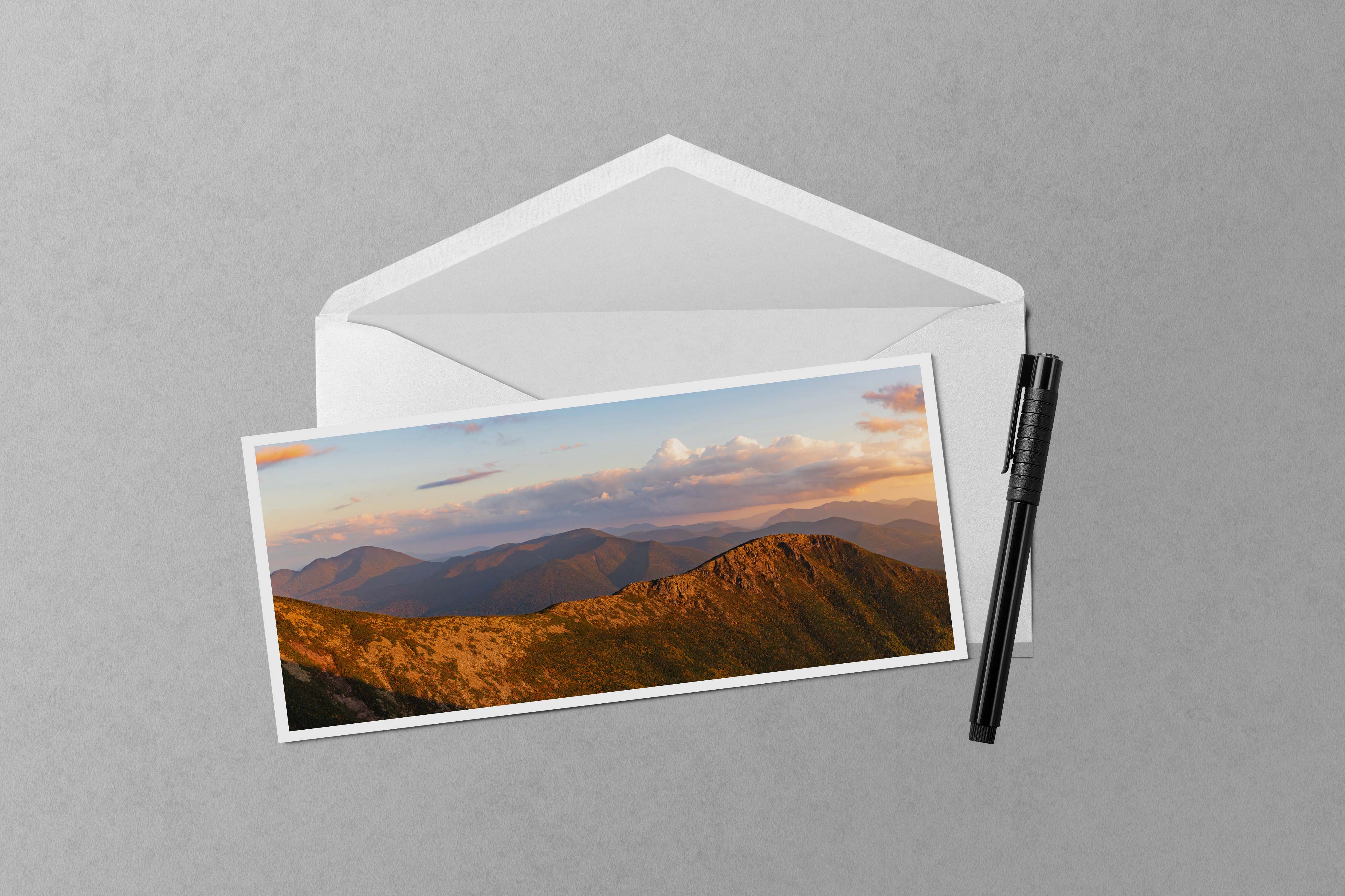 A panoramic photo of the rocky ridgeline of Bondcliff bathed in golden sunset light.